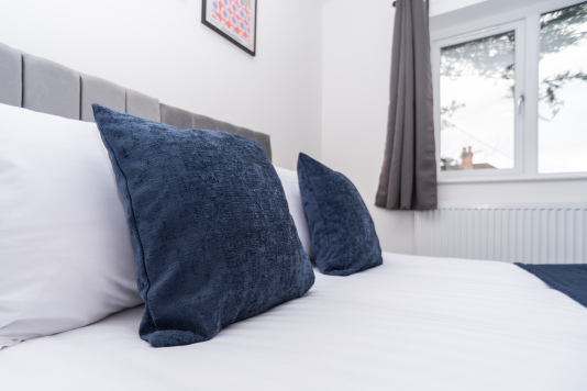 Bedroom dressed with hotel-crisp linens for convenience, style and ultimate comfort - perfectly prepared for a restful stay.