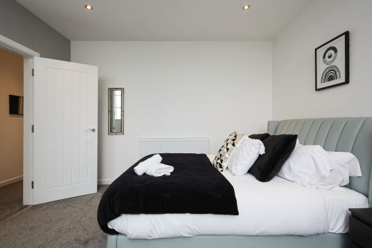 Settle into this serene double bedroom — a peaceful space to recharge.