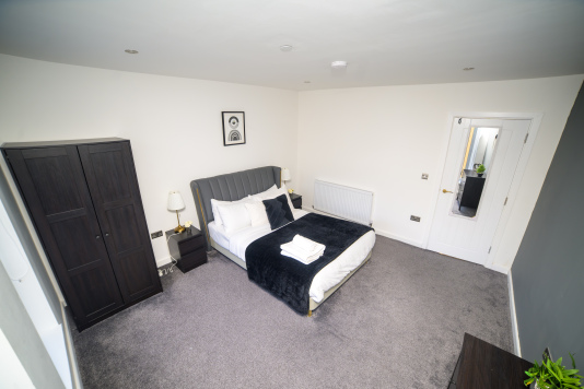 A warm and inviting double bedroom designed with your comfort in mind.