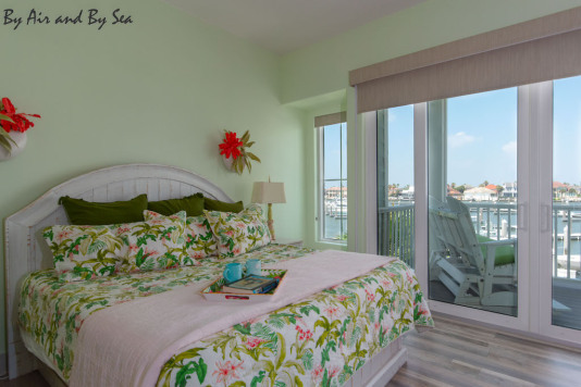 King primary suite has motorized shades, view of marina, 54