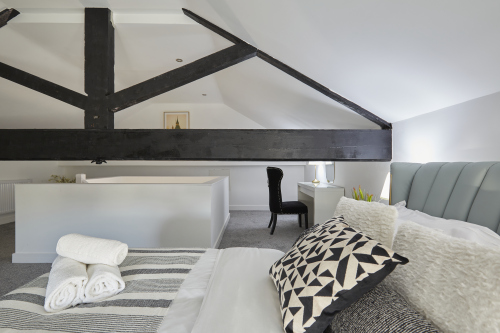 Sleep easy in this spacious double bedroom with soft linens and a relaxing ambience.