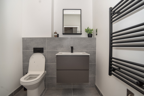 A modern en suite with a full shower, toilet and sink, designed for comfort and convenience.