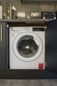 Convenient laundry area with washing facilities for longer stays.