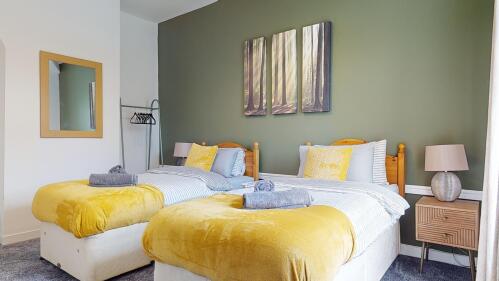 Bedroom 1 - spacious relaxing room with 2 single comfy beds & hanging rail for all your things