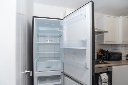 Large, clean fridge ideal for storing weekly groceries during longer work stays.