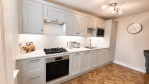 Stunning kitchen featuring a built-in oven, dishwasher, fridge freezer, and microwave for your convenience.
