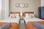 Comfortable twin single bed bedroom with a cosy and inviting atmosphere, perfect for a restful stay.
