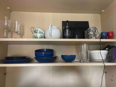 Various sized plates and bowls, cutlery, cooking dishes, glasses, teapot, cafetière 