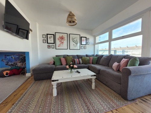 No. 28 Contemporary beach side property with sea views - Living room with kid's den and sliding doors to front balcony 