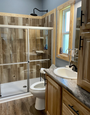 The Wyldwood Cabin bathroom features a glass enclosed shower. 