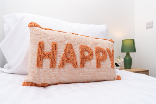 A stylish, modern bedroom designed for comfort, featuring hotel-quality bedding and a calming atmosphere.