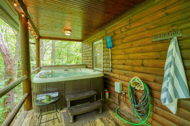 Outdoor Hot Tub on covered deck with wooded view