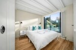 Woodside Cottage - 2nd floor master bedroom with king size bed and en suite shower room, dressing area and views onto the woodland beyond the garden