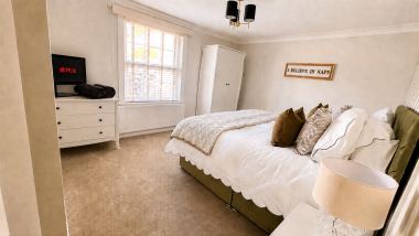 Luxurious master bedroom featuring a superking bed and a smart TV for ultimate comfort and entertainment.