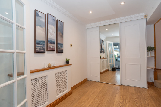 Light-filled, open hallway welcoming you into this spacious home and setting the tone for your stay.