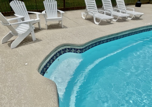Pool has bench on beach side