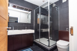 Ensuite with a spacious walk-in rain shower, offering a refreshing, modern spa-like experience.