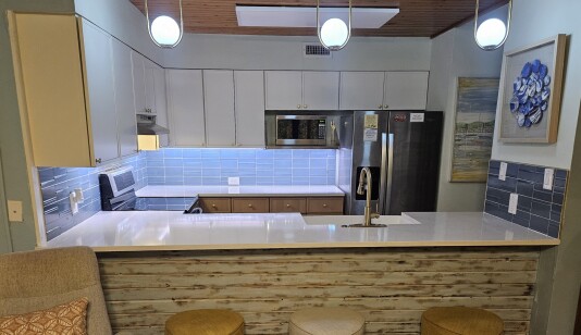 Newly remodeled kitchen has plentiful cabinets and counterspace