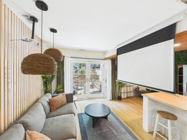 Step inside your private garden-level retreat, where warm wood ceilings and curated textures set the tone for your stay.