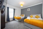 Wide view of bedroom with double beds