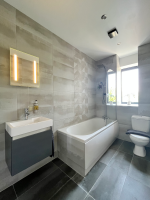 Luxury bathroom with large rainfall shower and pure Egyptian cotton towels.