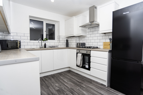 Bright, spacious kitchen with fully fitted appliances - including dishwasher, washing machine, fridge, toaster, microwave and kettle — everything you need for an easy, home-from-home stay.