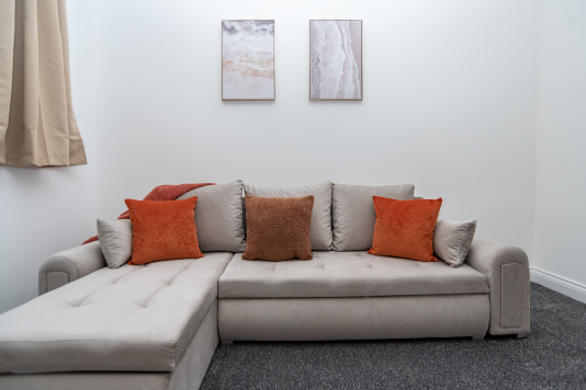 Comfortable sofa bed in the living room, fully dressed with fresh linens — perfect for flexible extra sleeping space.