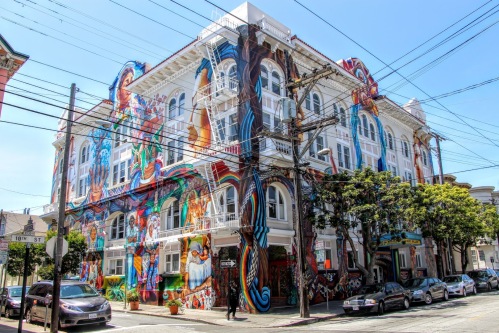 A colorful building with a large mural on the side