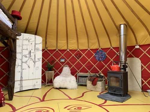 Cai Yurt living space with wood burning stove