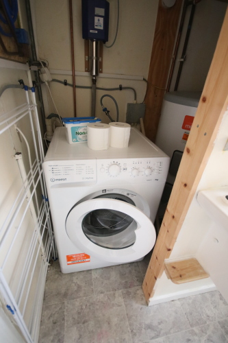 Washing Machine off the single bedroom bathroom