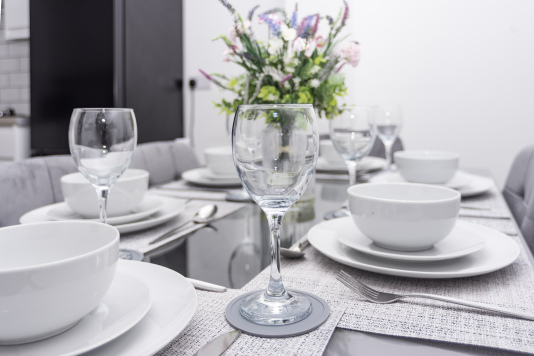 Dining table thoughtfully set with all the essentials - plates, cutlery and glassware carefully considered so you have everything you need for your stay.