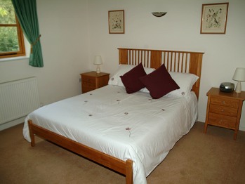Two bedroom cottage main bedroom with king-size bed