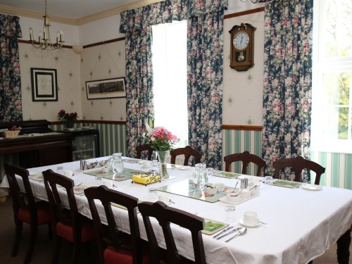 Guest dining room with large antique dining table