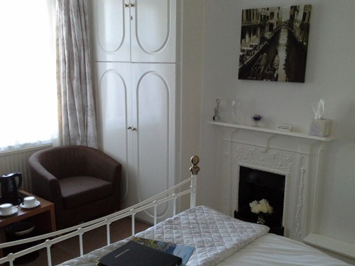 Guest room with original Victorian fireplace.