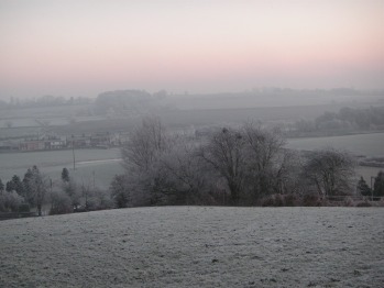 Frosty winter sunrise bottom field