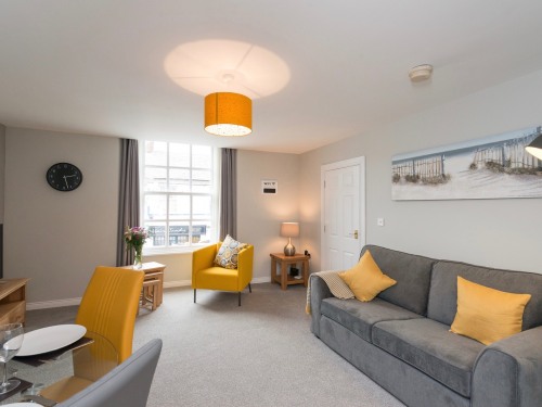 Hamilton House Holiday Apartments - Cosy living area with dining.