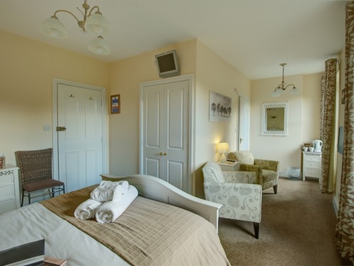 Room 5 - spacious king size en-suite bedroom with comfortable seating area overlooking beautiful St. John's Church