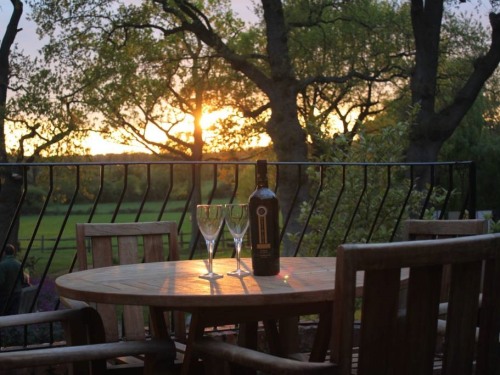 Enjoy a  sundowner, with views across ancient sheep meadows and woodland.