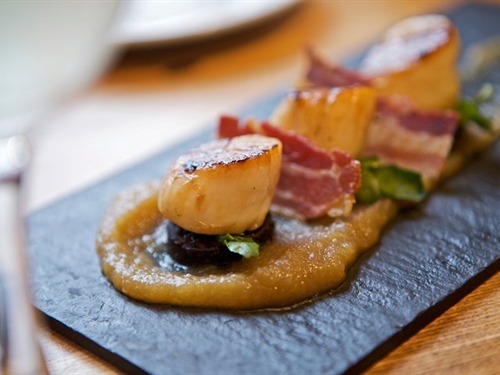 Seared Scottish king scallops, pancetta, apple puree with locally sourced black pudding.
