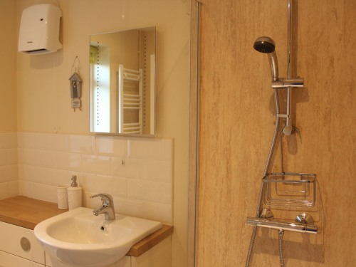 Bathroom with large walk-in shower, heated towel rail and underfloor heating
