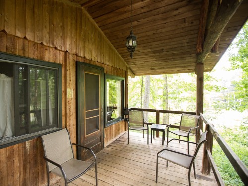 Each cottage features a private porch with lake view