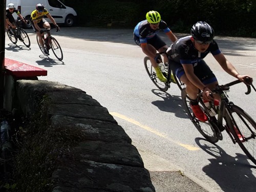 Cyclist speed past The Meetings in Wicklow race