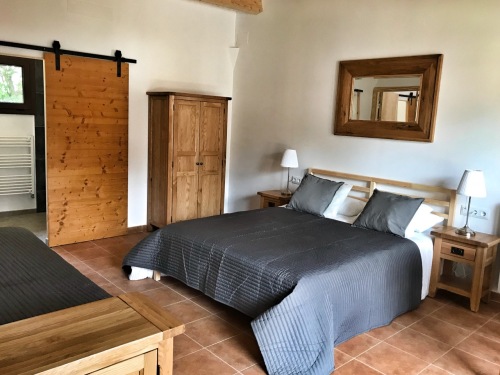 Garden suite with double bed and individual bed. Private walk in shower room.