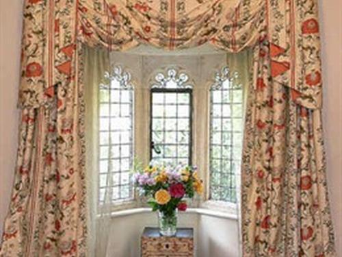 The Gothic Room is a luxury double room with a romantic stone mullioned bay window.