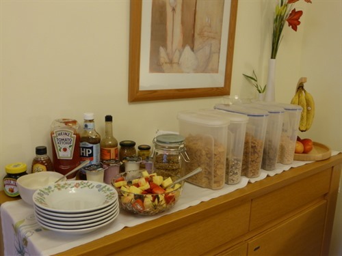 Selection of fresh fruit, cereals and yoghurts.