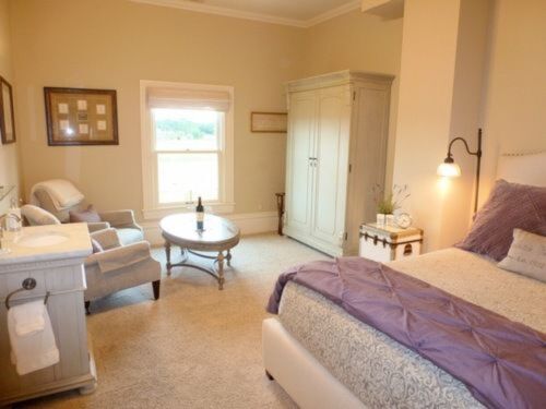 The Emma Room with south facing vineyard views in soft plum and neutral tones. Private bath with shower.