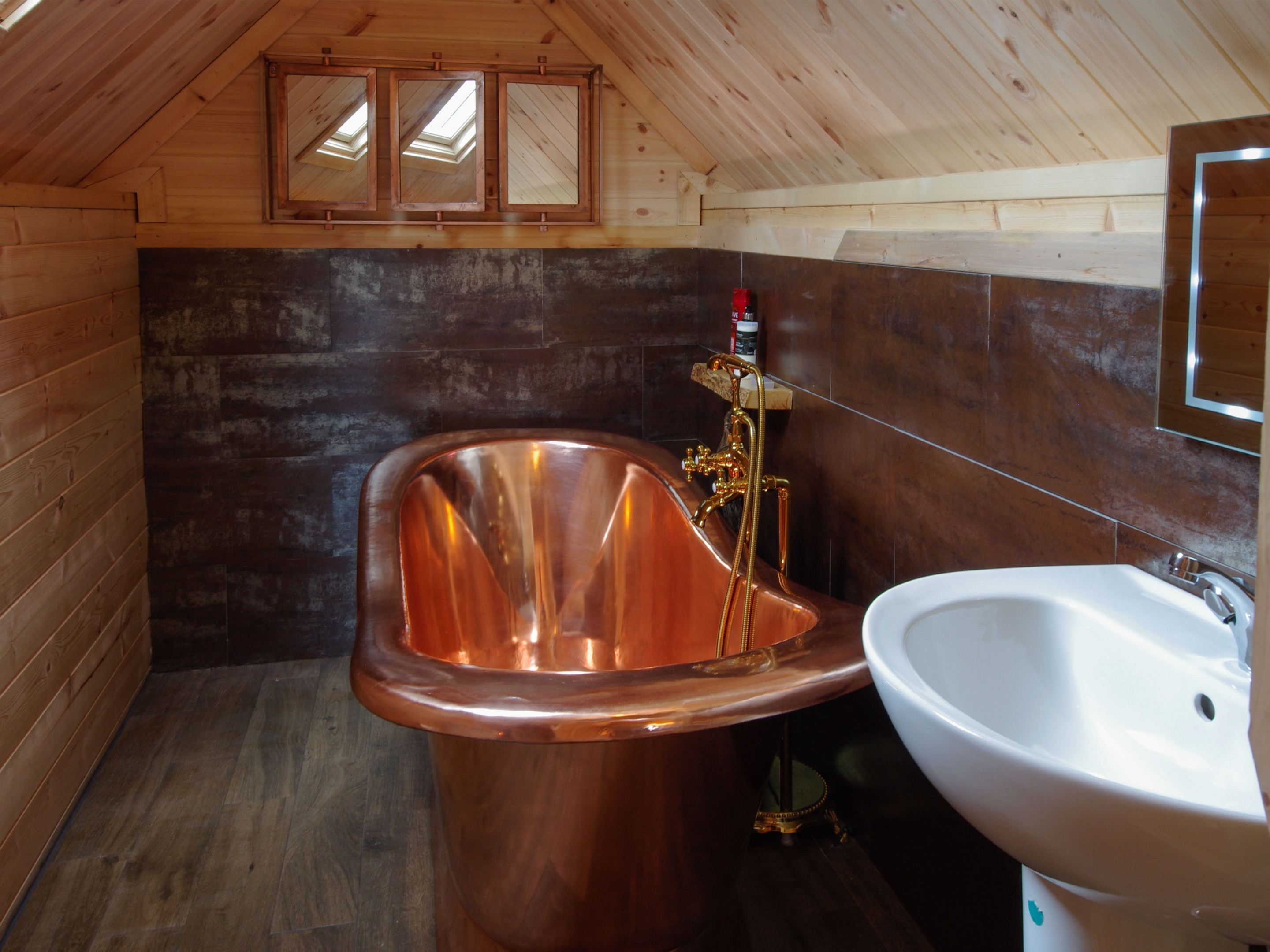 Bathroom with roll top copper bath