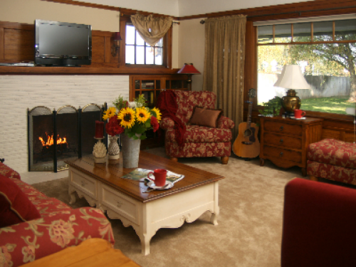 Vintner's cozy living room with a fireplace, television and DVD.