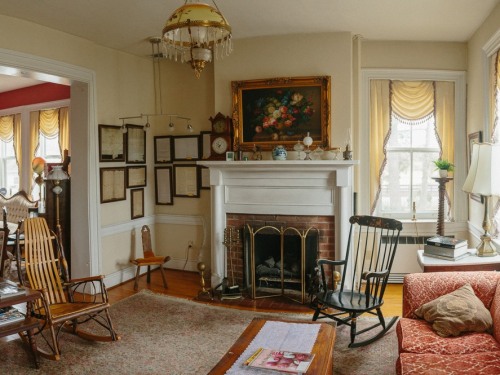 Sitting area with fireplace and antique furnishings