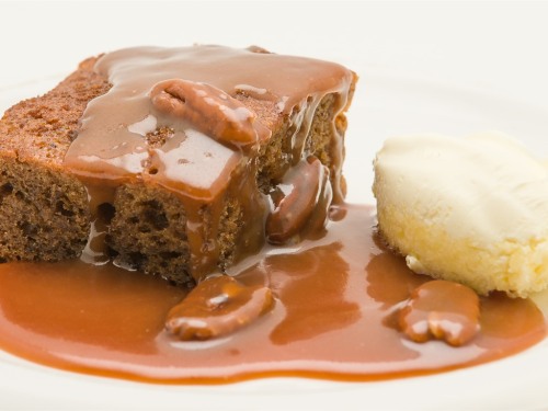 Homemade sticky toffee pudding with pecans and cornish clotted cream